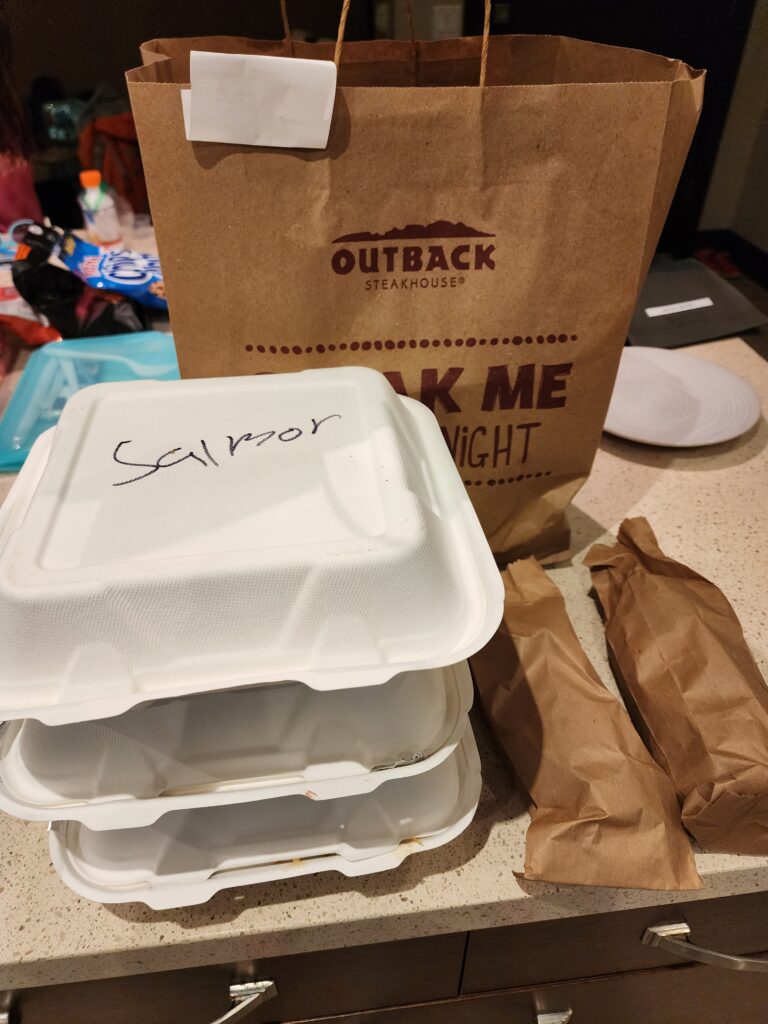 Outback Steakhouse takeout bags and containers made from recyclable and compostable materials.